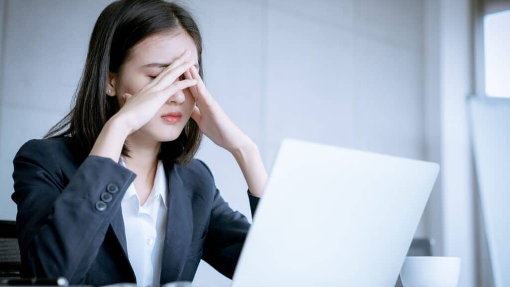frustrated woman sitting at her computer