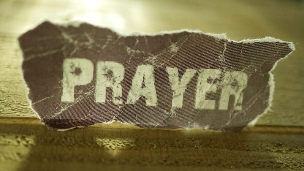 The word prayer on a piece of paper