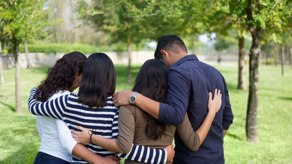 rear view of a family praying together