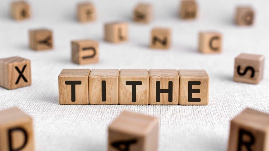 the word tithe spelled with wooden tiles