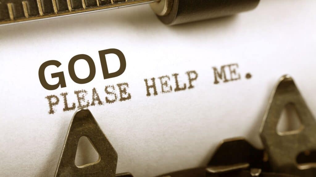 the words God please help me being typed on an antique typewriter